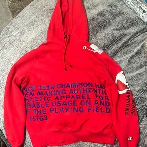 Red champion hoodie with print.